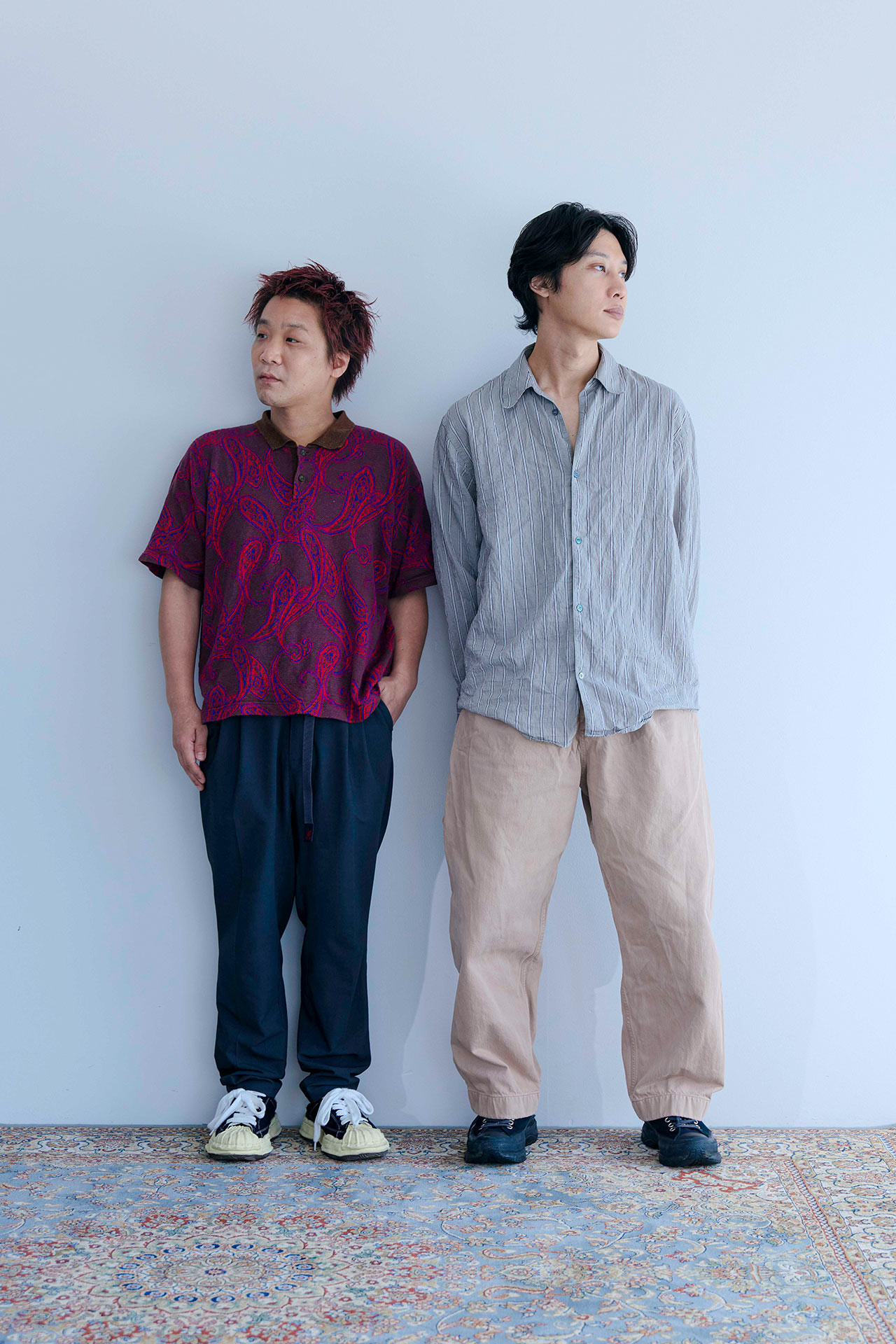 壁にそって立ちカメラを向く牧さんと長谷川さん