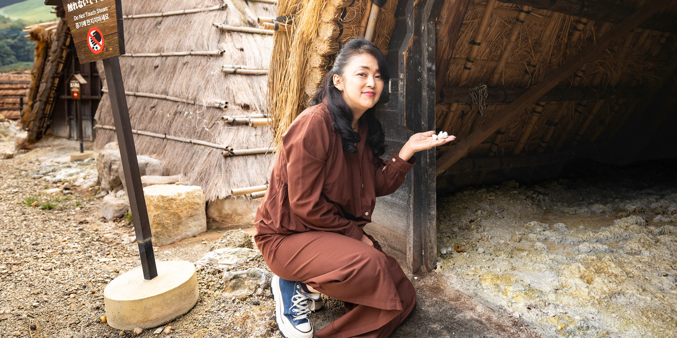 〈みょうばん湯の里〉で湯の花を手にする中島知子さん