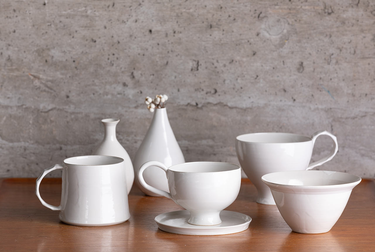 陶芸家・坂本和歌子さんが手がけたティーカップやマグカップ、一輪挿しなどが並んでいる