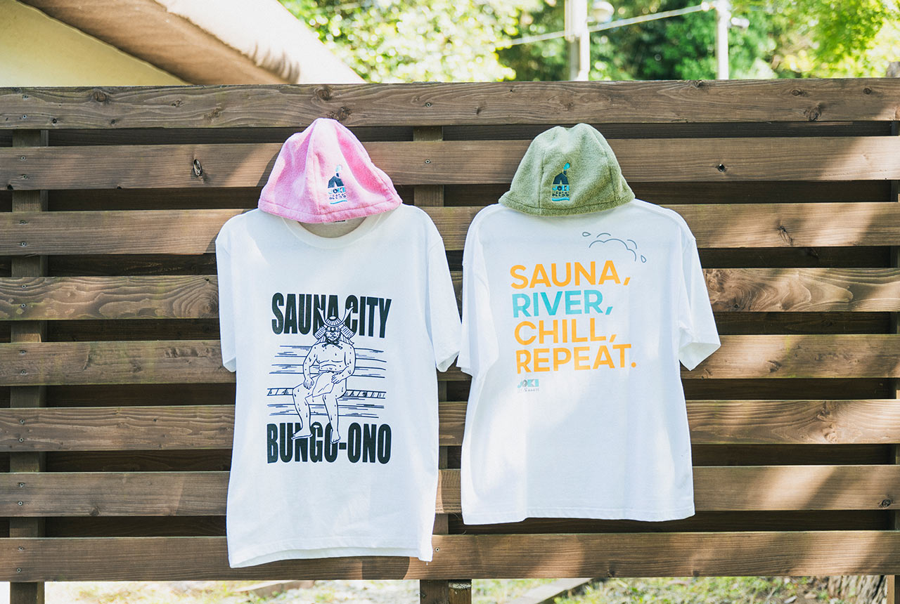 Ｔシャツとサウナハットのセットが２組、壁にかけられている